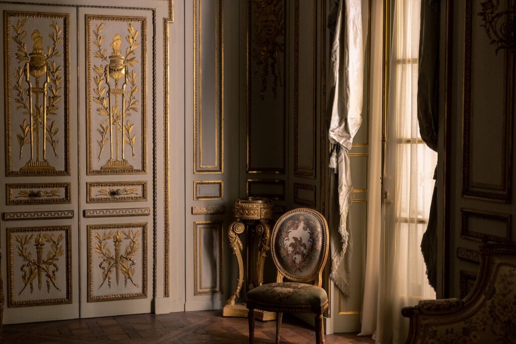 Luxurious interior featuring ornate gold design and classic furniture in a regal setting.